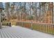 Spacious back deck with wooded views, perfect for outdoor living and entertaining. Includes a charcoal colored railing at 2170 Charleston Pl, Lithia Springs, GA 30122