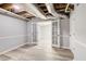 Finished basement room with white trim, light gray flooring, and french doors at 2170 Charleston Pl, Lithia Springs, GA 30122