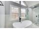 Spa-like bathroom with a freestanding tub, a glass-enclosed shower, and modern fixtures, creates a tranquil retreat at 2170 Charleston Pl, Lithia Springs, GA 30122