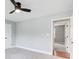 A bright and airy bedroom with light gray walls, carpet, and a ceiling fan, offering a cozy atmosphere at 2170 Charleston Pl, Lithia Springs, GA 30122