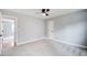 A light-filled bedroom with gray walls, soft carpeting, and a ceiling fan, creating a welcoming space at 2170 Charleston Pl, Lithia Springs, GA 30122