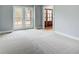 Light-filled bedroom with plush carpet, neutral wall paint, and large windows providing ample natural light at 2170 Charleston Pl, Lithia Springs, GA 30122