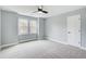 Neutral bedroom with large windows, carpeted floor, and ceiling fan at 2170 Charleston Pl, Lithia Springs, GA 30122