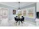 Charming dining area with modern light fixture, white trim, and large windows overlooking the yard at 2170 Charleston Pl, Lithia Springs, GA 30122