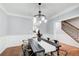 Dining room with large windows and modern decor and view to staircase at 2170 Charleston Pl, Lithia Springs, GA 30122