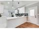 Modern kitchen with white cabinets, quartz countertops, stainless steel appliances, and gray subway tile backsplash at 2170 Charleston Pl, Lithia Springs, GA 30122