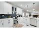 Modern kitchen with white cabinets, quartz countertops, stainless steel appliances, and gray subway tile backsplash at 2170 Charleston Pl, Lithia Springs, GA 30122