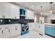 Modern kitchen featuring white cabinets, stainless steel appliances, and striking black backsplash and white quartz countertops at 2170 Charleston Pl, Lithia Springs, GA 30122