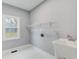 Clean laundry room features white tile flooring, a utility sink, and a bright window at 2170 Charleston Pl, Lithia Springs, GA 30122