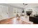 Cozy living room with hardwood floors, stone fireplace, and comfortable seating near large windows at 2170 Charleston Pl, Lithia Springs, GA 30122