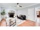 Living room with a stone fireplace, a ceiling fan, and hardwood floors at 2170 Charleston Pl, Lithia Springs, GA 30122