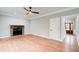 Inviting living room with hardwood floors, a ceiling fan, and a stone fireplace for a cozy ambiance at 2170 Charleston Pl, Lithia Springs, GA 30122