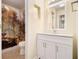 Full bathroom with white vanity, decorative mirror, and shower with curtain at 257 Country Club Dr, Jonesboro, GA 30238