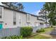 Beautiful townhome with tall windows, a well kept lawn and privacy fence at 257 Country Club Dr, Jonesboro, GA 30238