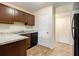 Galley kitchen showing granite countertops, wood cabinets, and closet doors to the right at 257 Country Club Dr, Jonesboro, GA 30238