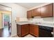 Galley kitchen featuring granite counters, wood cabinets, and a black dishwasher at 257 Country Club Dr, Jonesboro, GA 30238