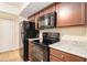 Well-equipped kitchen with black appliances and ample storage space at 257 Country Club Dr, Jonesboro, GA 30238
