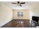 Inviting living room with hardwood floors, ceiling fan, and view of the backyard at 257 Country Club Dr, Jonesboro, GA 30238