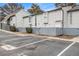 Exterior view of the unit featuring a parking lot with multiple parking spaces and a charming gray picket fence at 257 Country Club Dr, Jonesboro, GA 30238
