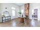 Spacious entryway with hardwood floors, a console table, and an exposed brick fireplace at 359 Woodward Se Ave, Atlanta, GA 30312