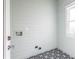 Laundry room with light green walls, patterned tile floor, and built-in shelving at 359 Woodward Se Ave, Atlanta, GA 30312