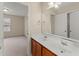 Bathroom featuring a double sink vanity, a large mirror, and neutral walls at 498 Anglewood Trce, Stockbridge, GA 30281