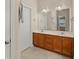 Bathroom with double vanity, wood cabinets, and large mirror at 498 Anglewood Trce, Stockbridge, GA 30281