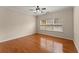 Bright bedroom with hardwood flooring, ceiling fan, and natural light from window at 498 Anglewood Trce, Stockbridge, GA 30281