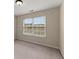 Well-lit bedroom featuring a large window, neutral walls, and comfortable carpeting at 498 Anglewood Trce, Stockbridge, GA 30281