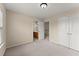 Comfortable bedroom featuring neutral paint and carpeting with easy access to attached bathroom at 498 Anglewood Trce, Stockbridge, GA 30281