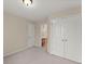 A bright bedroom featuring neutral walls, carpet, and a closet, offering a serene and comfortable space at 498 Anglewood Trce, Stockbridge, GA 30281