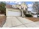 Charming two-story home with a spacious driveway and well-manicured lawn, showcasing its inviting curb appeal at 498 Anglewood Trce, Stockbridge, GA 30281