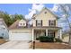 Charming yellow two-story home with attached garage and inviting front porch at 498 Anglewood Trce, Stockbridge, GA 30281