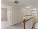 Upstairs hallway featuring wooden railing, neutral paint, carpeting, and natural light at 498 Anglewood Trce, Stockbridge, GA 30281