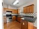 Kitchen featuring stainless steel appliances, granite countertops, and wooden cabinets at 498 Anglewood Trce, Stockbridge, GA 30281