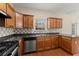 Kitchen showcasing stainless steel appliances, tile backsplash, and wooden cabinetry at 498 Anglewood Trce, Stockbridge, GA 30281