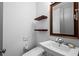 Well-lit half bathroom with stylish floating shelves, modern fixtures, and a sleek, wall-mounted toilet for added convenience at 3630 Peachtree Ne Rd # 2207, Atlanta, GA 30326