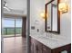 Bright bathroom vanity with marble countertop, stylish lighting, and doorway to a bedroom with stunning skyline view at 3630 Peachtree Ne Rd # 2207, Atlanta, GA 30326