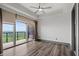 Bedroom with hardwood floors, a ceiling fan and large windows with access to the balcony at 3630 Peachtree Ne Rd # 2207, Atlanta, GA 30326