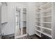 Walk-in closet with built-in shelves and mirrored door at 3630 Peachtree Ne Rd # 2207, Atlanta, GA 30326