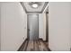 Hallway with modern gray door and matching trim, illuminated by stylish ceiling lights, and a beautiful wood-look floor at 3630 Peachtree Ne Rd # 2207, Atlanta, GA 30326