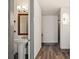 Entryway hallway leads to stylish bathroom with pedestal sink and modern lighting, complemented by attractive hardwood floors at 3630 Peachtree Ne Rd # 2207, Atlanta, GA 30326