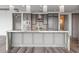 A kitchen island made of light gray cabinets and topped with a marbled countertop at 3630 Peachtree Ne Rd # 2207, Atlanta, GA 30326