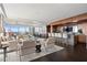 Bright open-concept living area with a bar, dark wood floors, and floor-to-ceiling windows with beautiful views at 3630 Peachtree Ne Rd # 2207, Atlanta, GA 30326