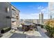 Elegant outdoor dining area with fireplace and city views on a rooftop terrace at 3630 Peachtree Ne Rd # 2207, Atlanta, GA 30326