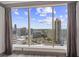 Stunning city view from the large window with floor-to-ceiling windows and elegant gray curtains at 3630 Peachtree Ne Rd # 2207, Atlanta, GA 30326