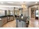 Elegant kitchen featuring a large island, stainless steel appliances and travertine tile at 1125 Lake Shore Overlook, Alpharetta, GA 30005