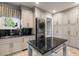 Well-organized laundry room featuring modern washer and dryer with black countertops at 1125 Lake Shore Overlook, Alpharetta, GA 30005