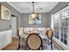 Bright dining room features hardwood floors, a chandelier, and a table set for six at 1035 Bridle Path Dr, Lawrenceville, GA 30045