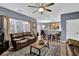 Spacious living room featuring hardwood floors, a leather couch, and a view into the kitchen at 1035 Bridle Path Dr, Lawrenceville, GA 30045